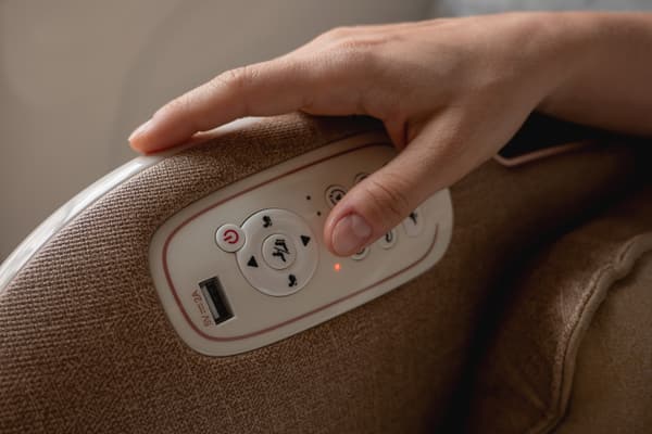 iStock Credit: Jun A close-up of a person pressing a massage chair button